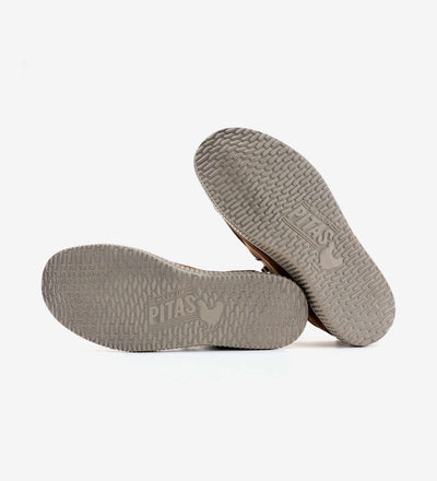 Durable gray soles of WP150 Bruce by Pitas moc-toe shoes showcasing the textured pattern and brand logo for superior grip and comfort.